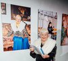 TikTok grandma Kristiana poses in front of her portrait by Patrick Essex.