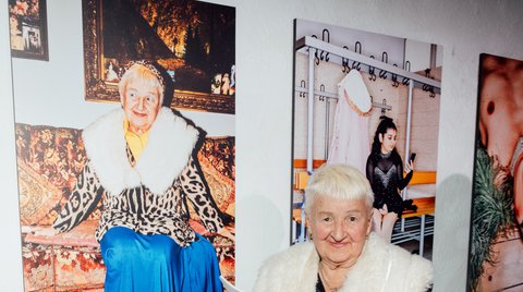 TikTok grandma Kristiana poses in front of her portrait by Patrick Essex.