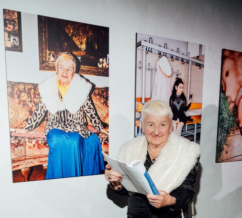 TikTok grandma Kristiana poses in front of her portrait by Patrick Essex.